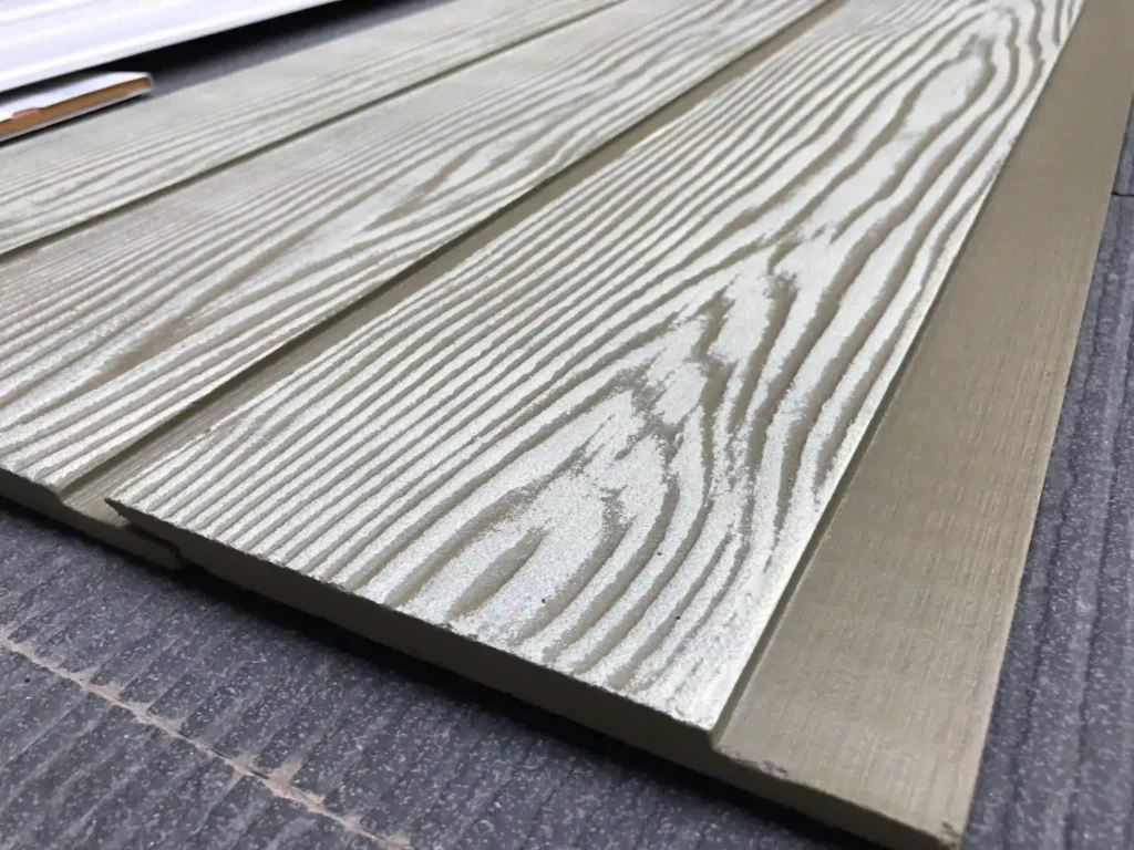 Close-up of the fiber cement board and batten siding exhibits on the ground
